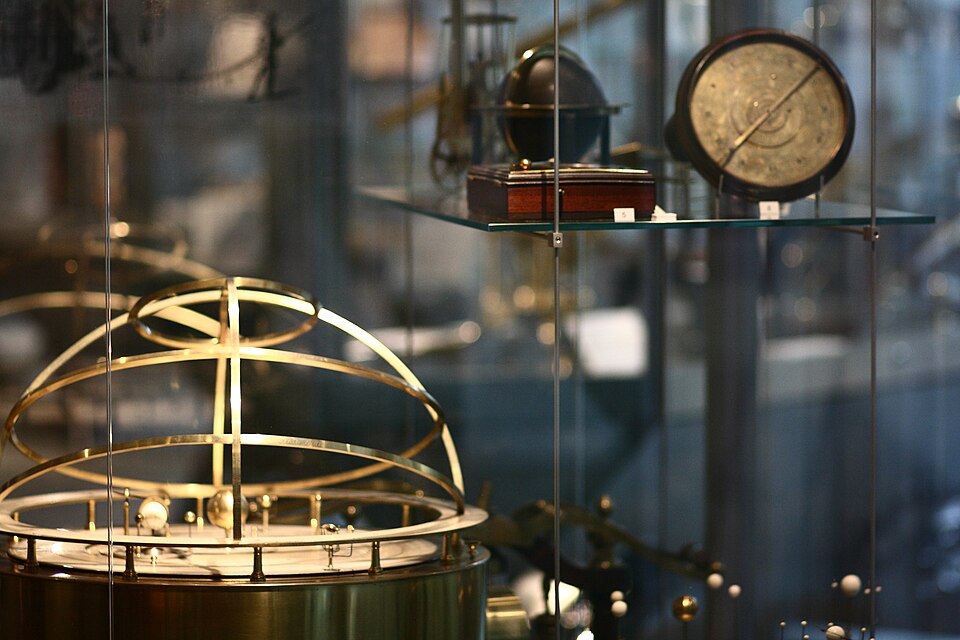 Scientific instruments behind glass with brass and blue tones